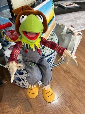 Kermit the frog scarecrow . Has wired hands and legs so that you can sit him up.